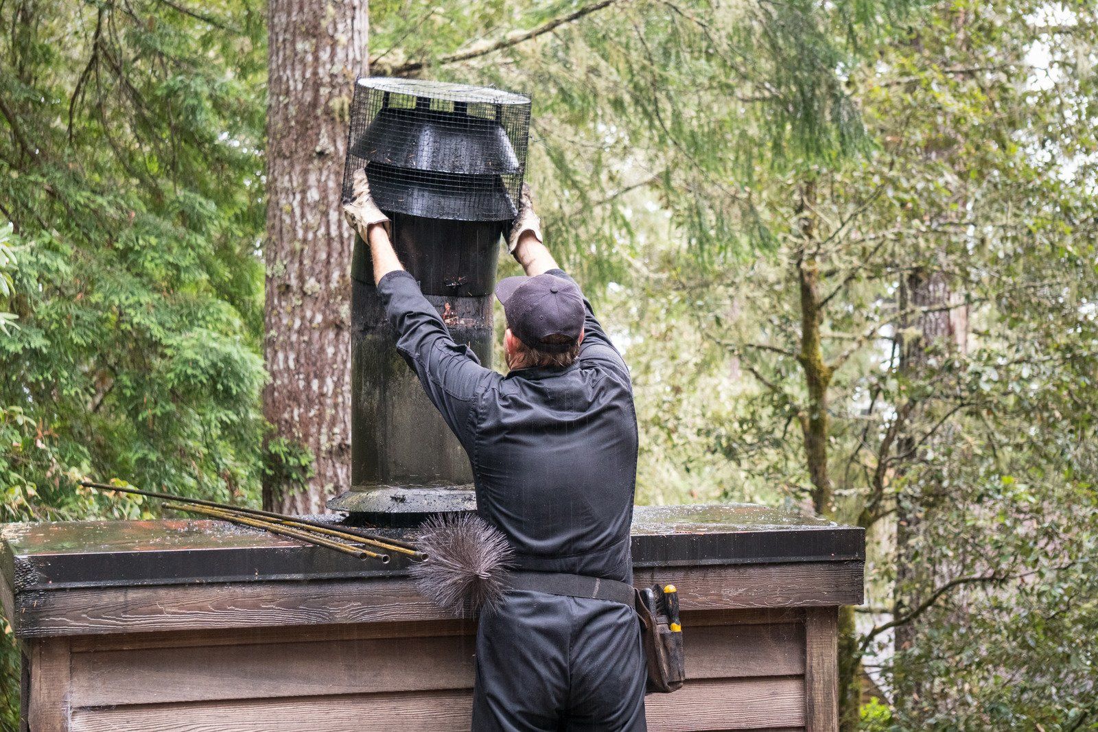 A man wearing a mask is loading boxes into a van