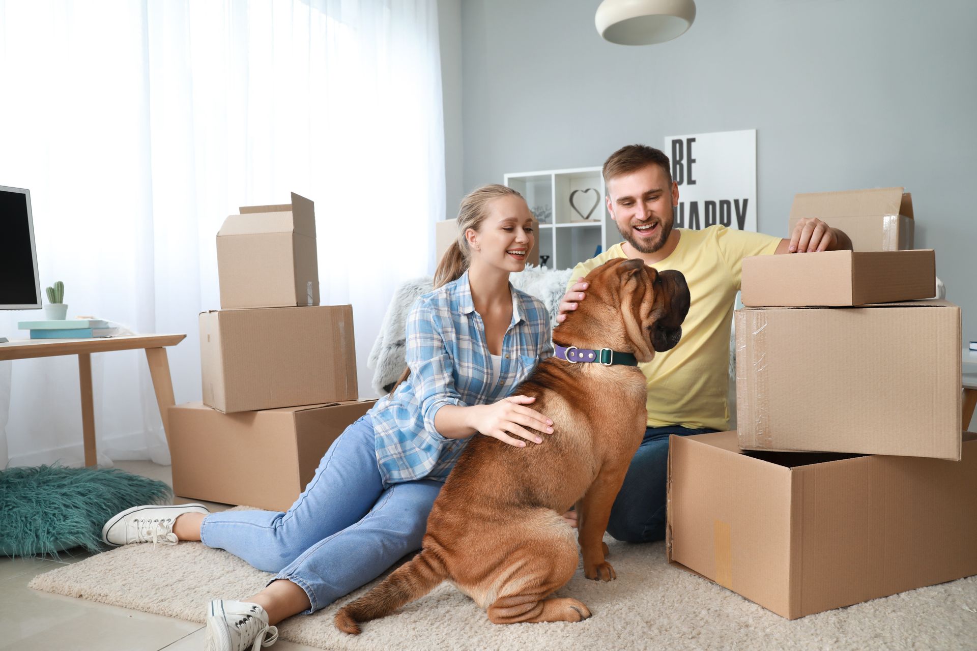 Couple with cute dog after moving into new house.