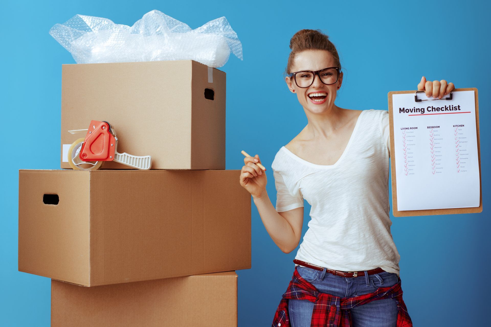 Happy woman with moving checklist near cardboard box, ready to call Central Van; movers in Cranberry