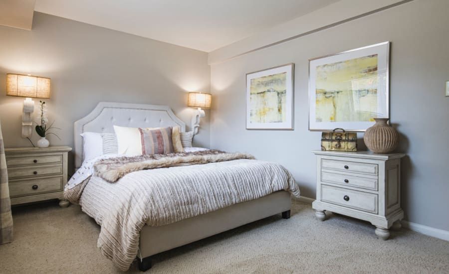 A bedroom with a bed , nightstand , and dresser at Westgate Apartments & Townhomes in Manassas, VA.