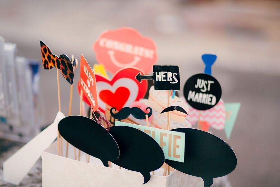 A bunch of photo booth props are sitting on a table.