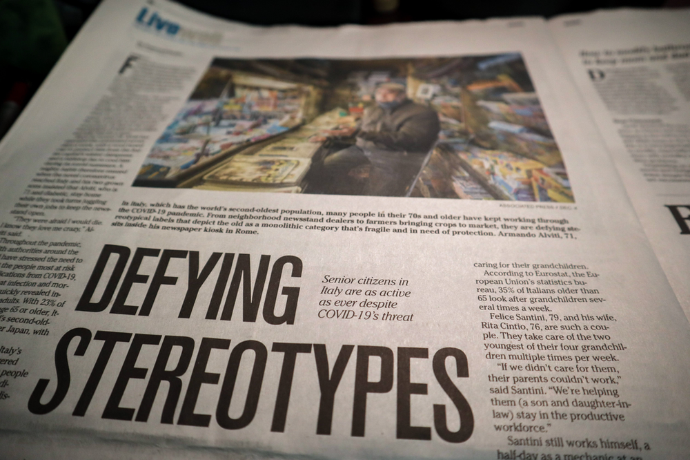 A newspaper article about defying stereotypes is on a table.
