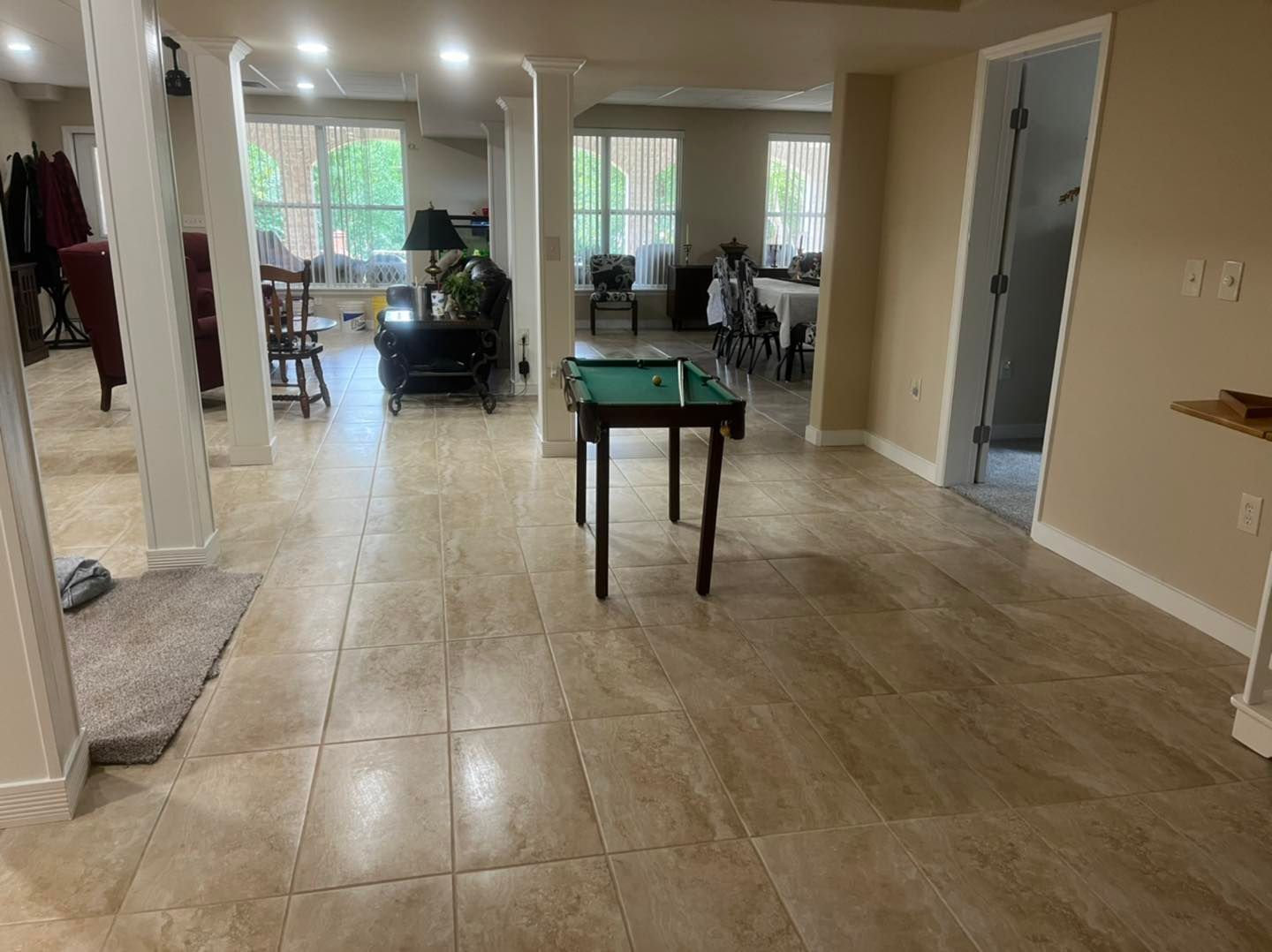 There is a pool table in the middle of the room.