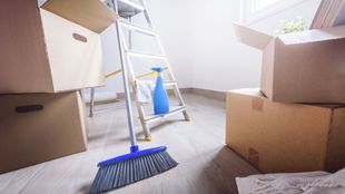 floor in front of a pile of cardboard boxes.