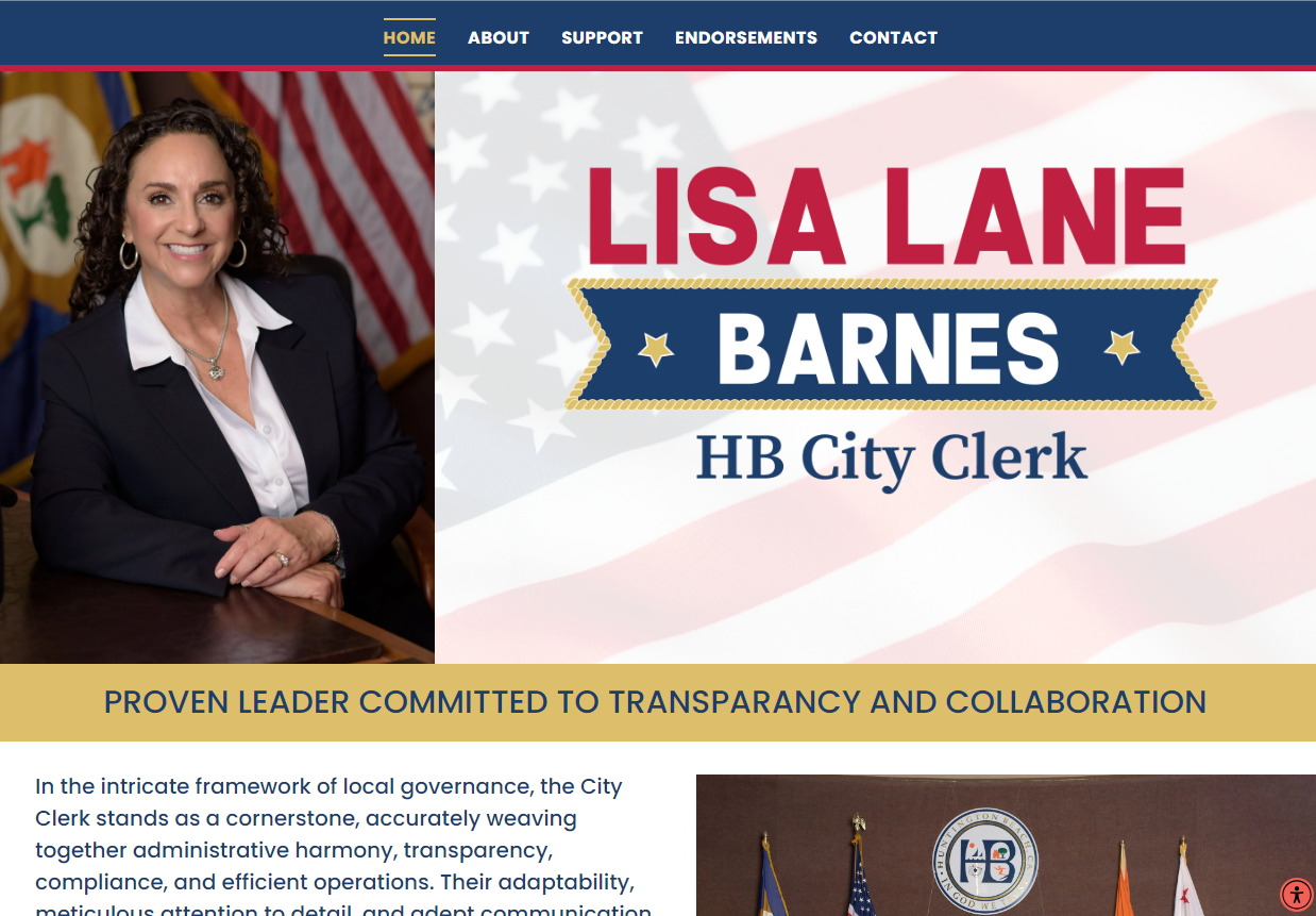 Lisa Lane Barnes, HB City Clerk, in front of an American flag.
