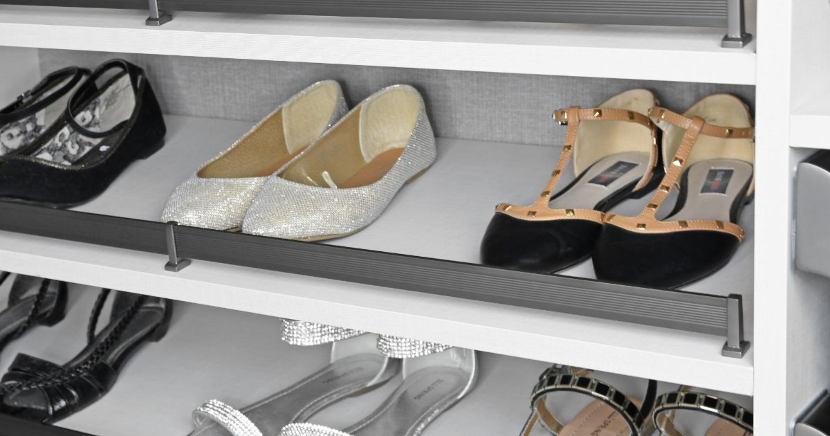 Shoes on shelves in a closet, including flats and heels, neatly organized.