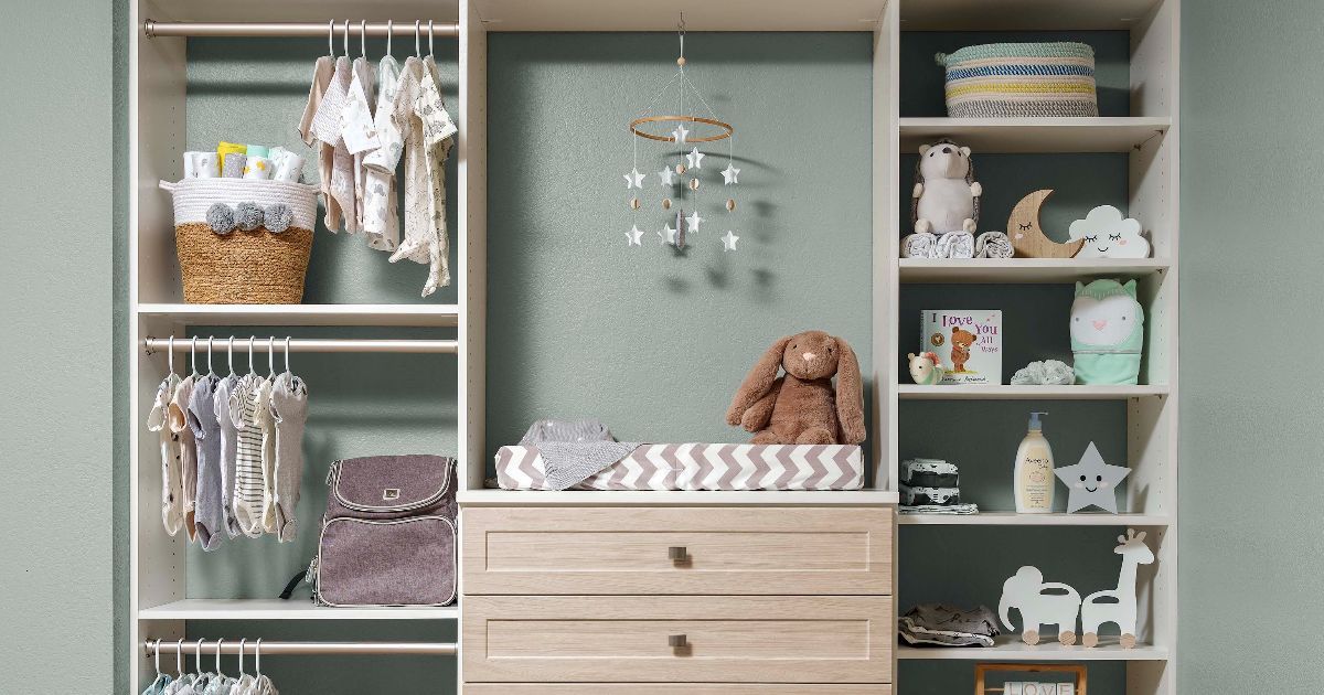 A kids closet with shelves, clothing rods, and a changing table. It features baby clothes, toys, and decor in soft colors.