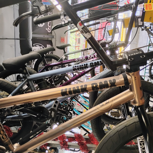 A person wearing red shoes is riding a bike