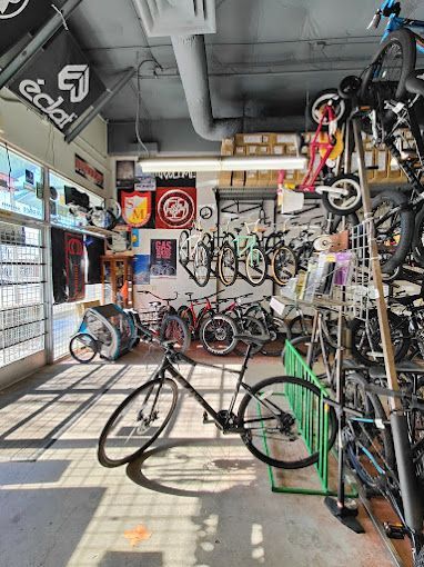 A bicycle is sitting on a rack in a bicycle shop.
