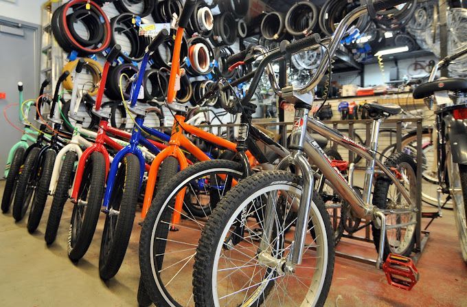 A bunch of bikes are lined up in a room