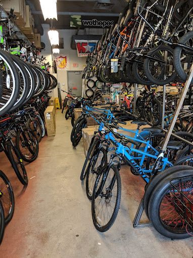 A bicycle store filled with lots of bicycles and tires.