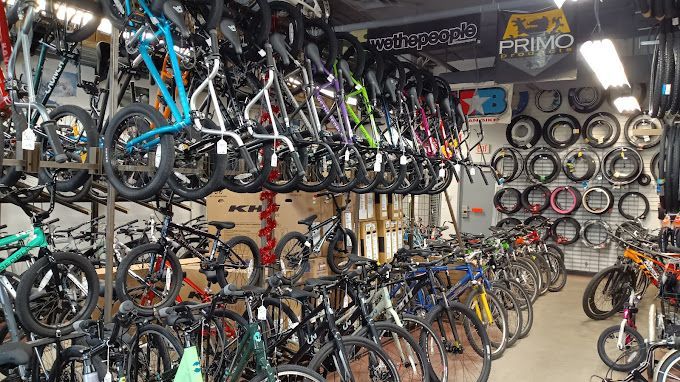 A bicycle store filled with lots of bicycles and tires.