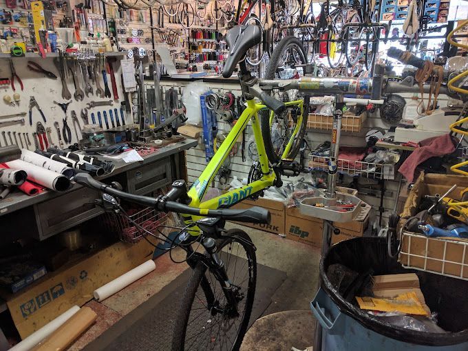 A bicycle is being repaired in a bicycle shop.