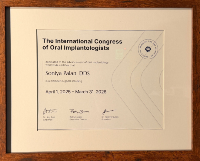A framed certificate from The International Congress of Oral Implantologists issued to Soniya Palan, DDS.