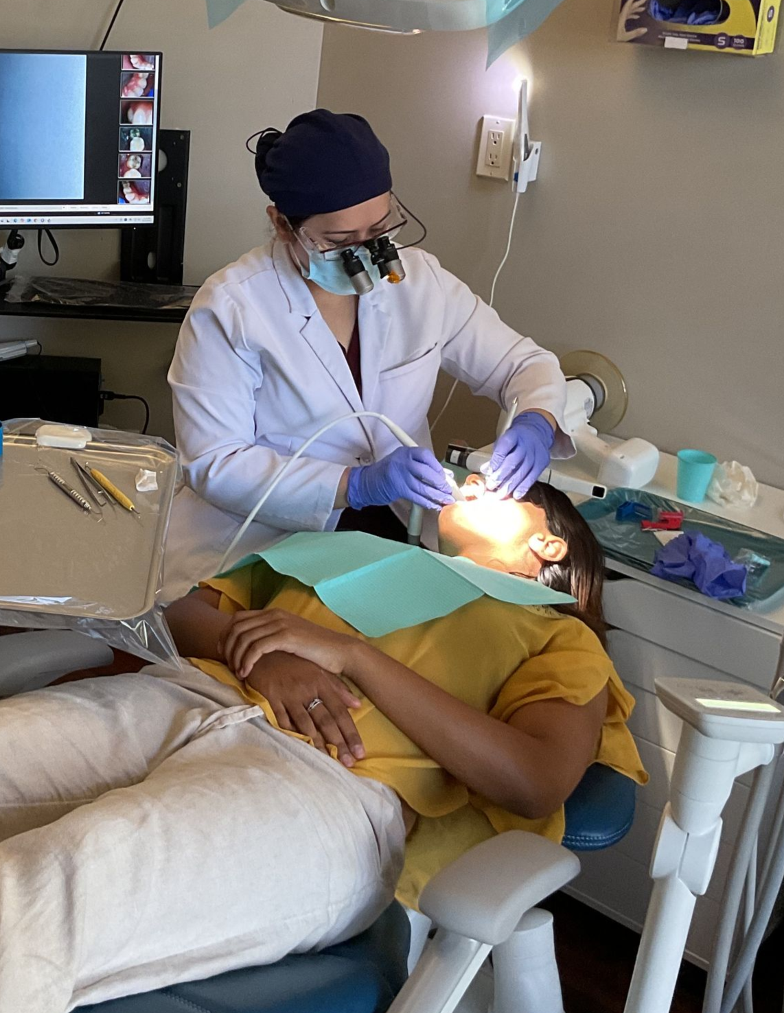 A man is having his teeth examined by a dentist.
