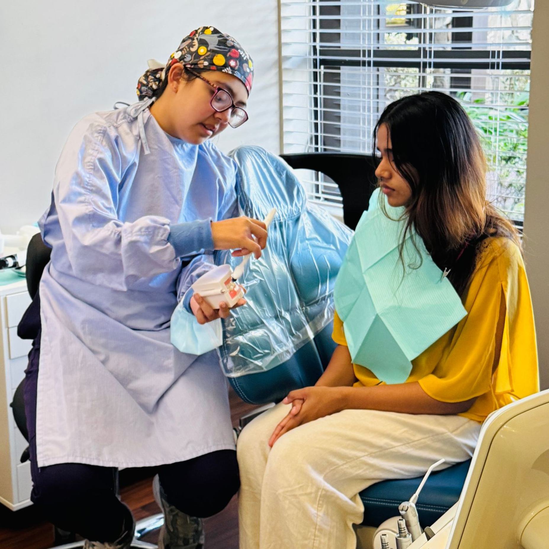 A group of dentists are holding a tooth in their hands.