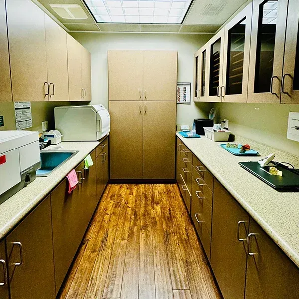 A long kitchen with lots of cabinets and counter tops