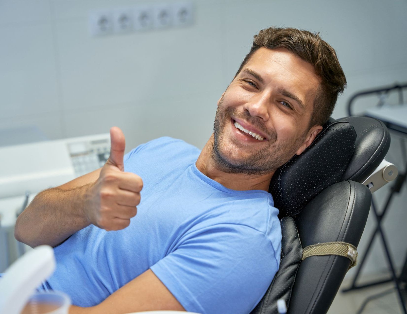 A dentist is working on a patient in a dental chair