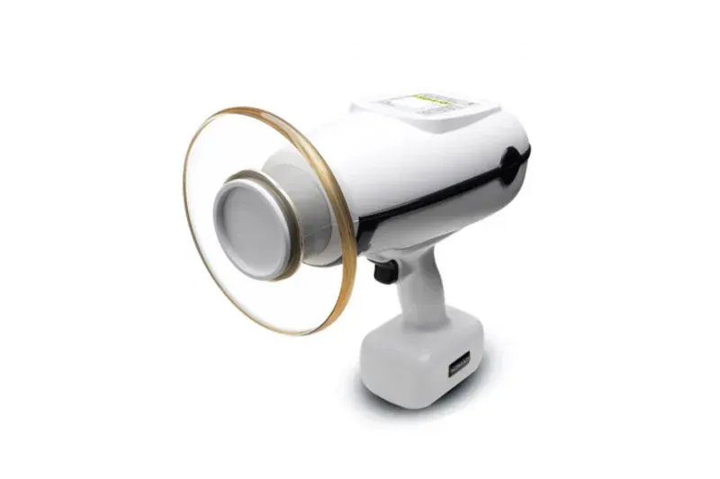 A white device with a gold ring around it on a white background