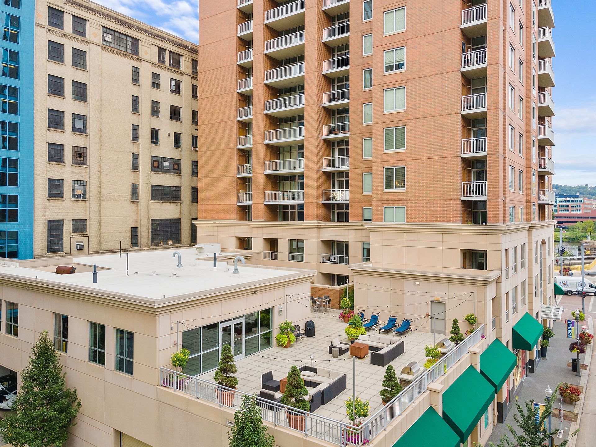 An aerial view of a large building with a patio in front of it.
