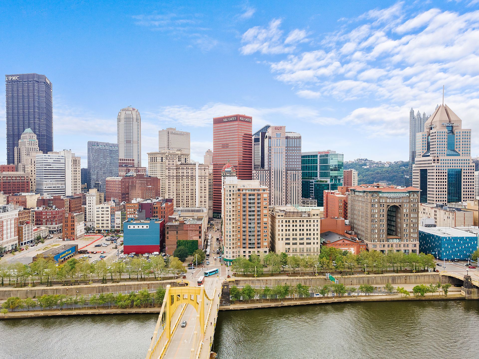 An aerial view of a city skyline with a bridge over a river.