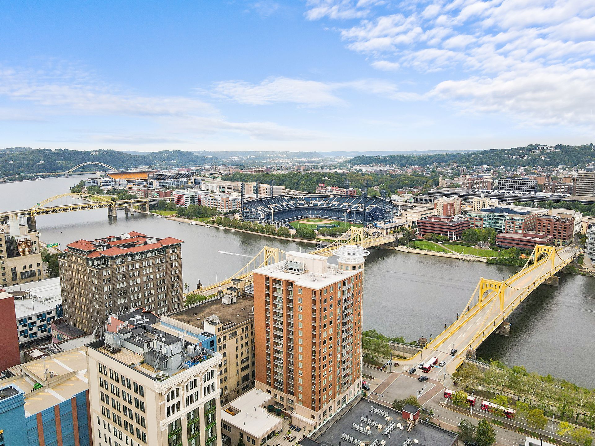 An aerial view of a city with a bridge over a river.