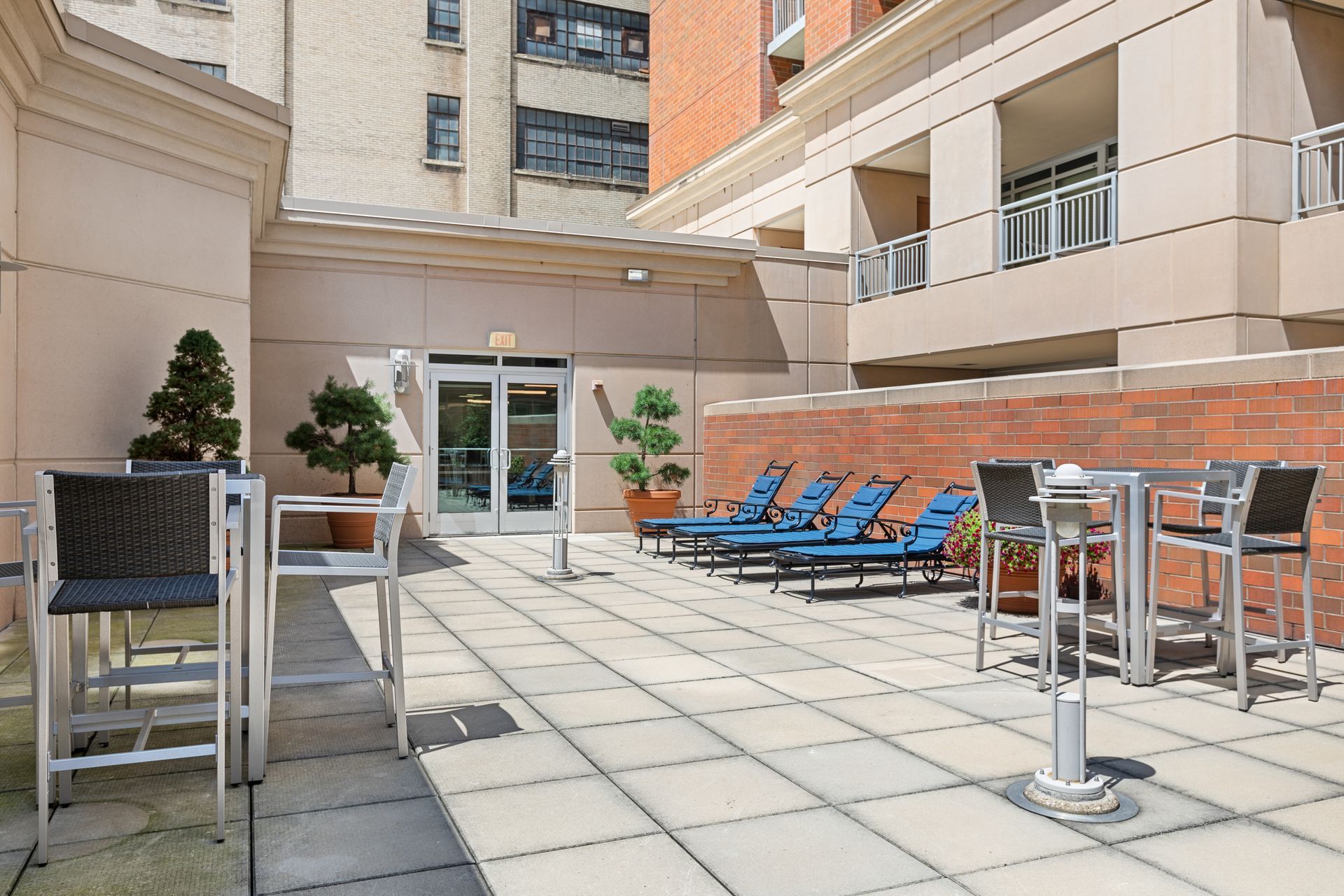A patio with tables and chairs in front of a building