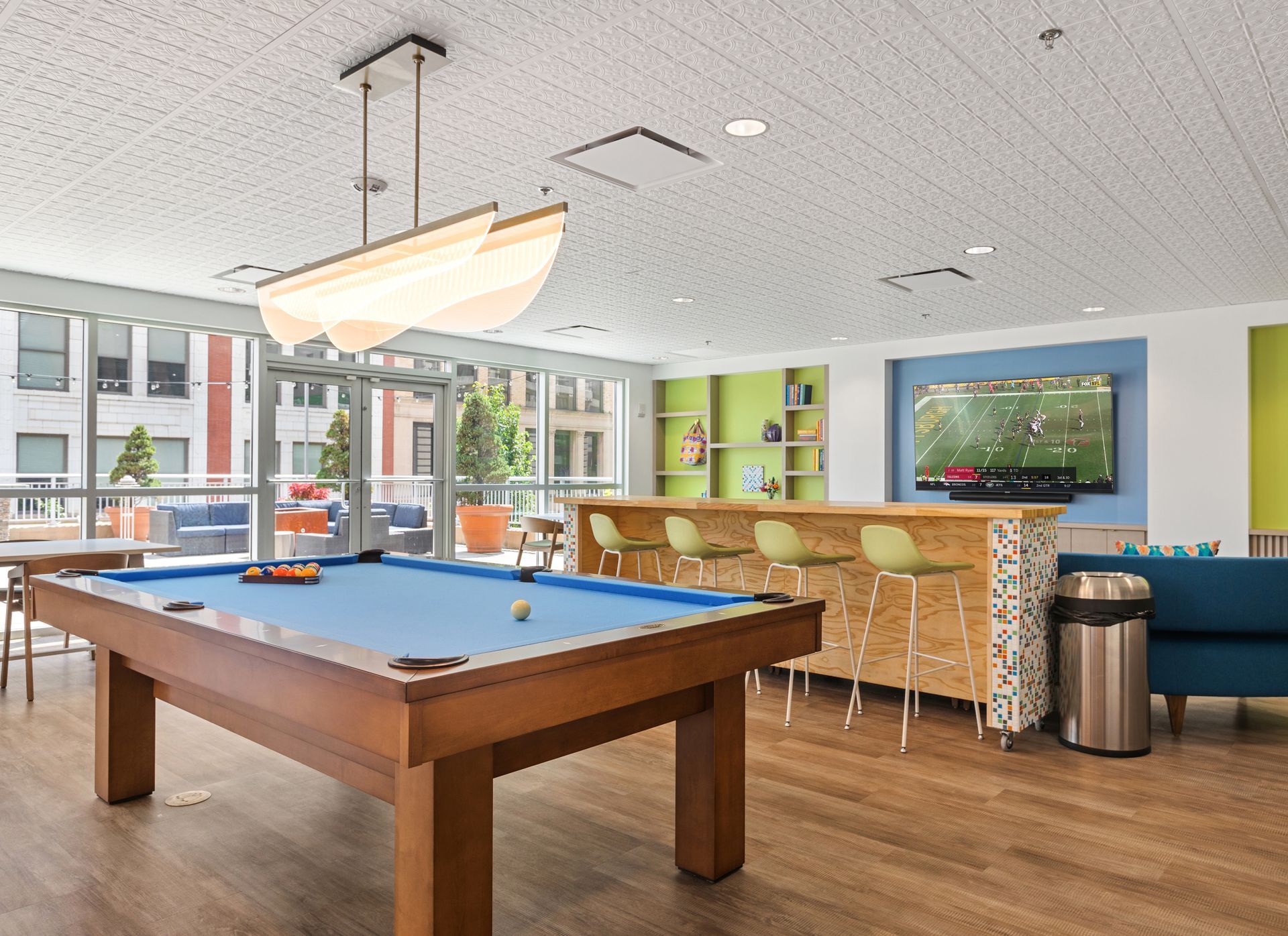 There is a pool table in the middle of the room.