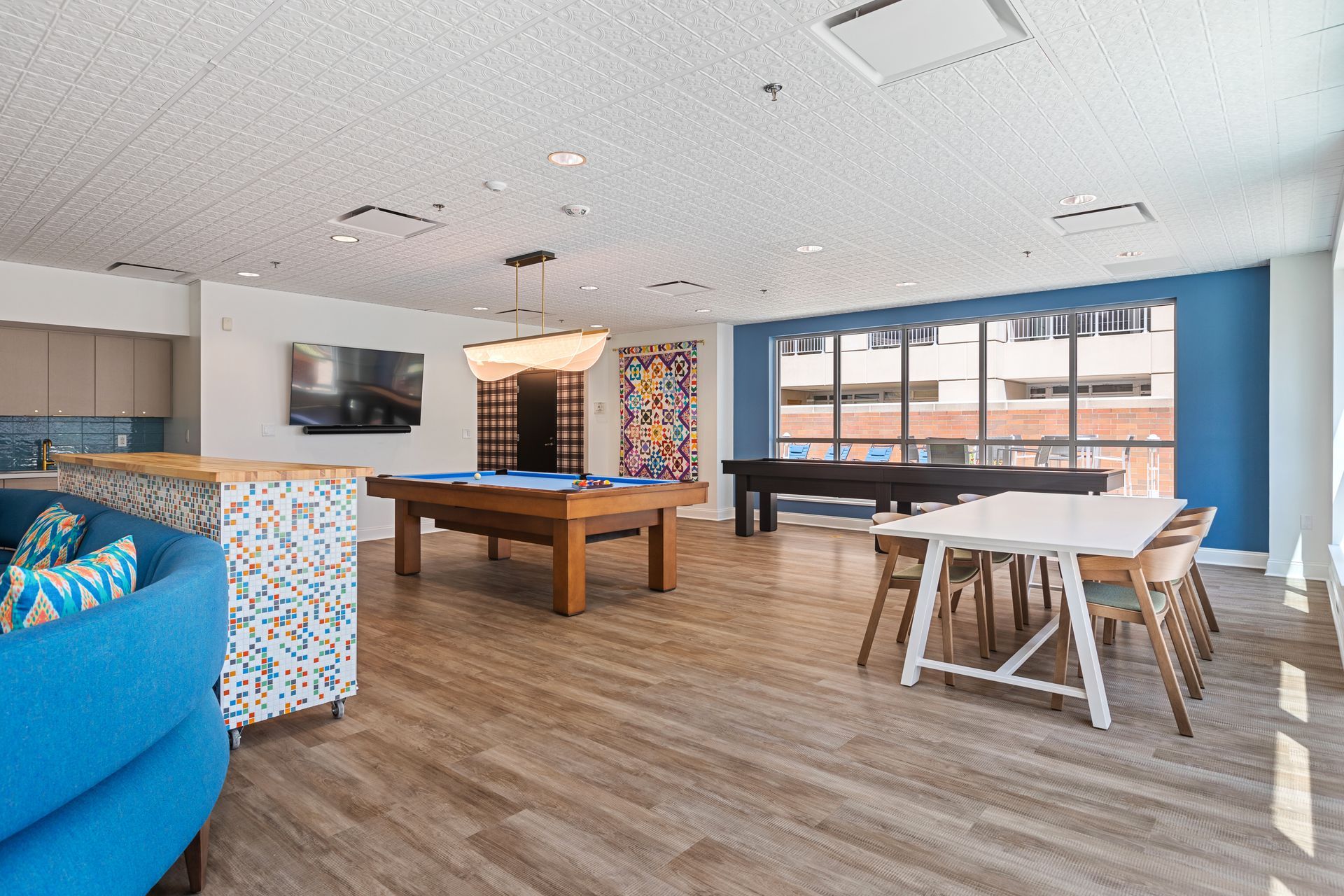 There is a pool table in the middle of the room.