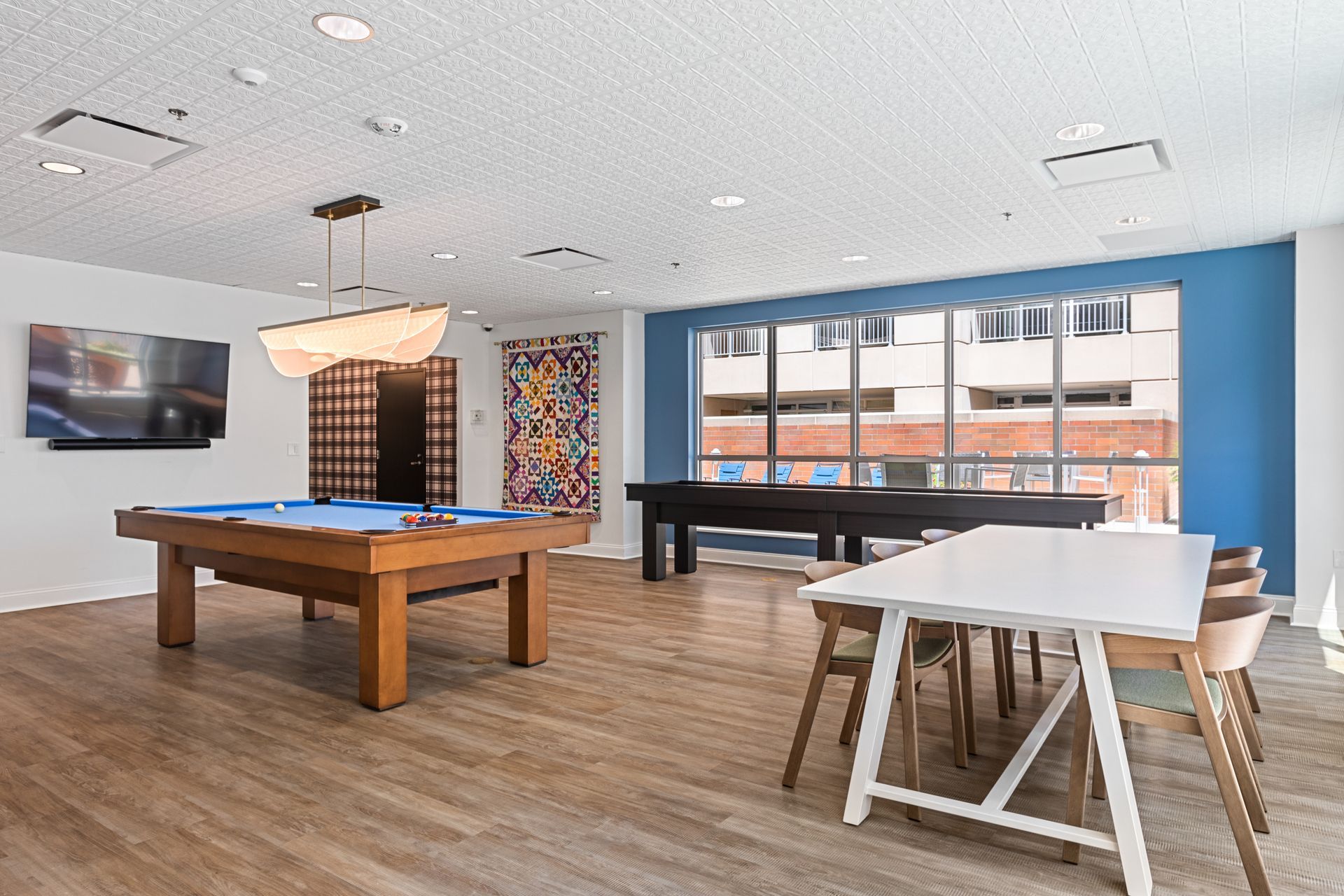 There is a pool table in the middle of the room.