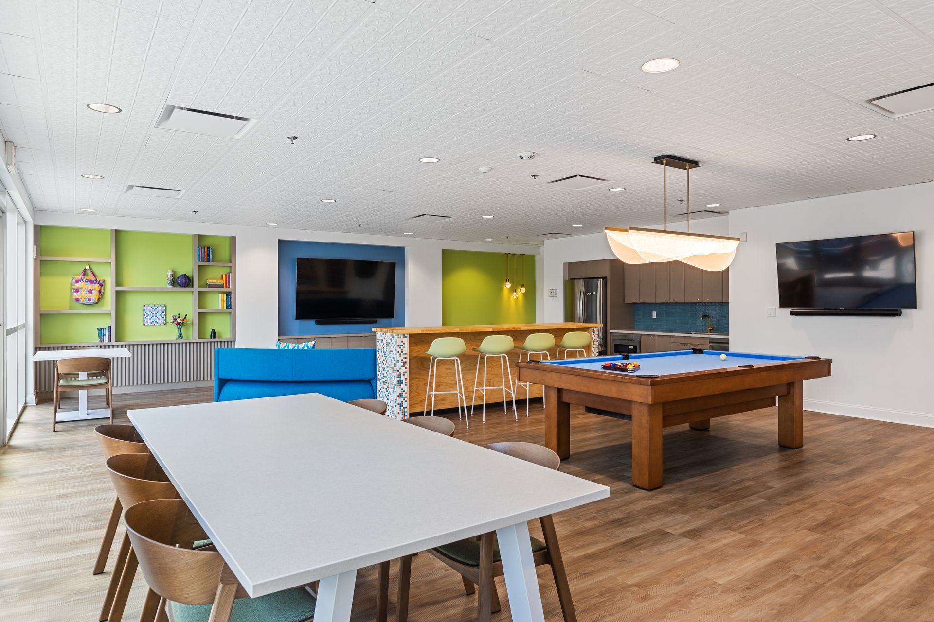 There is a pool table in the middle of the room.