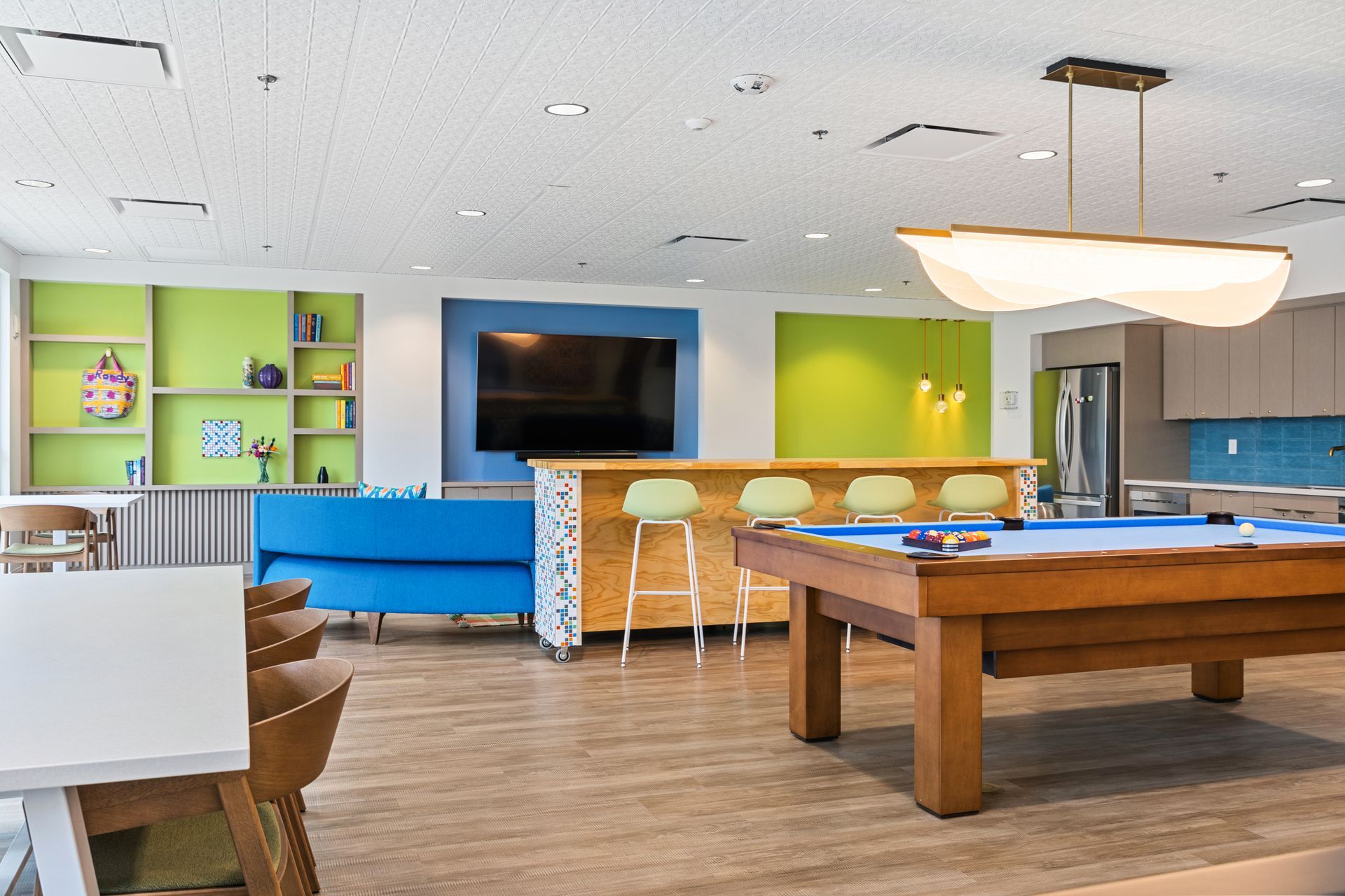 There is a pool table in the middle of the room.