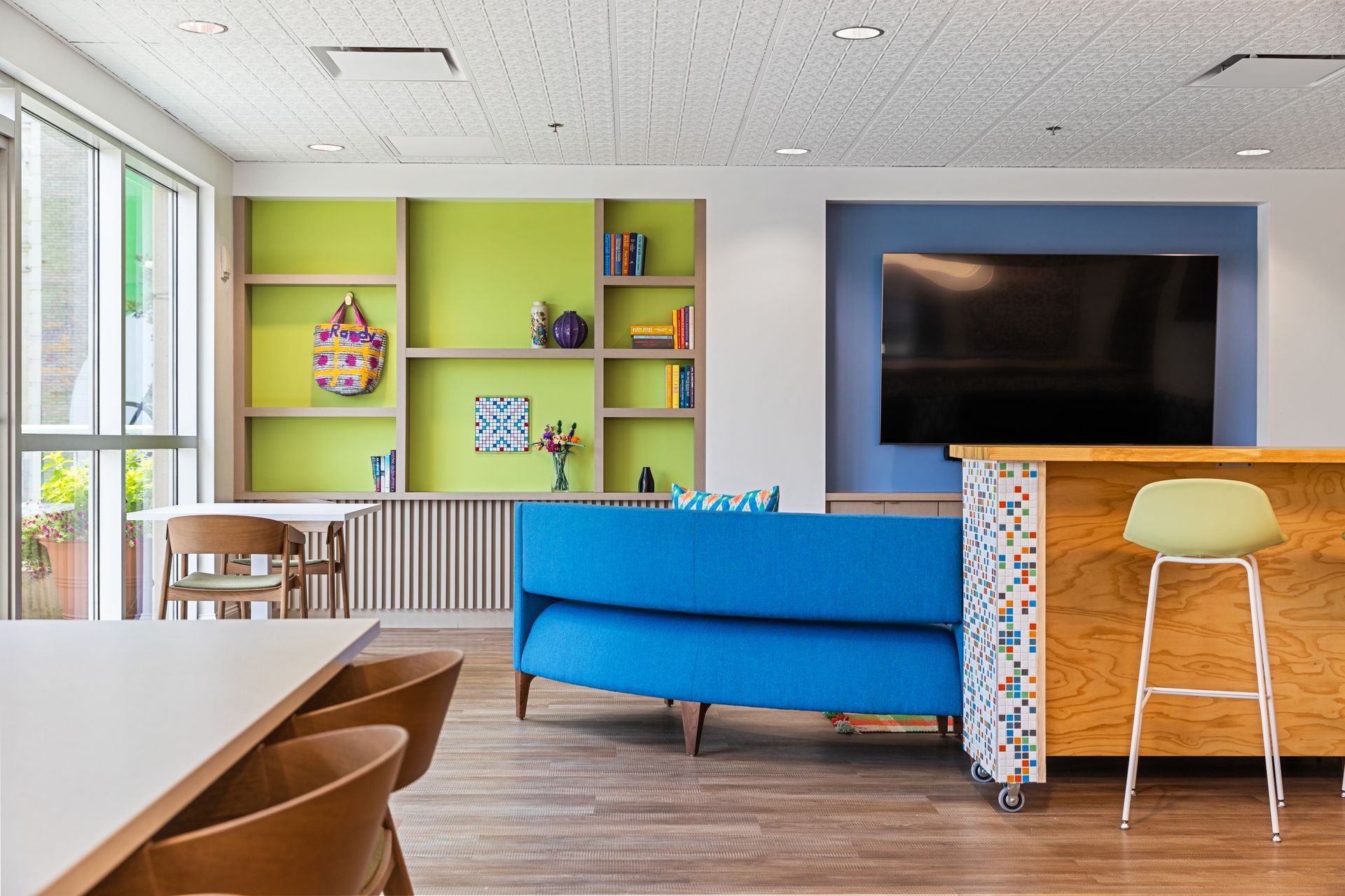A living room with a blue couch and a flat screen tv