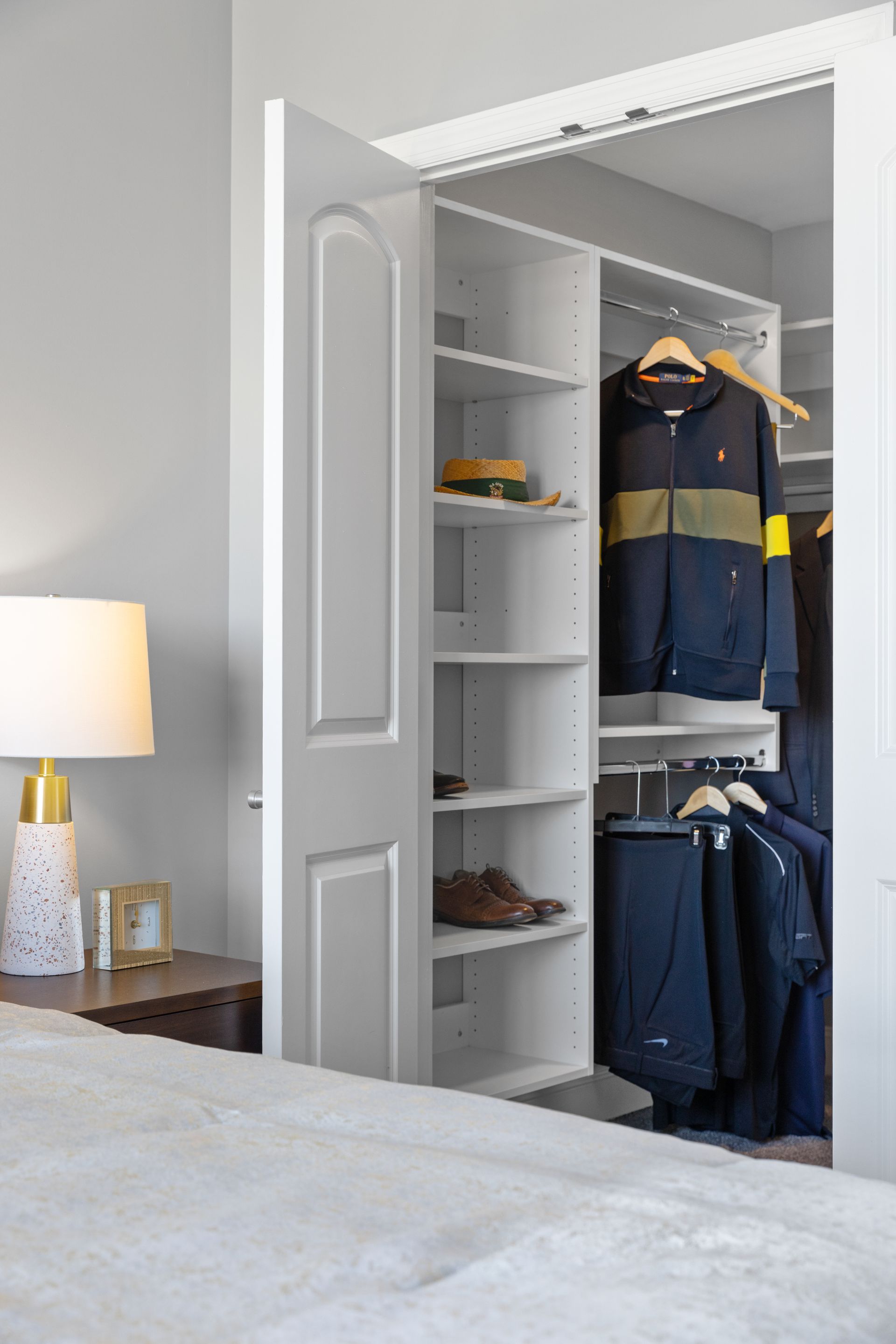 A bedroom with a walk in closet and a bed.