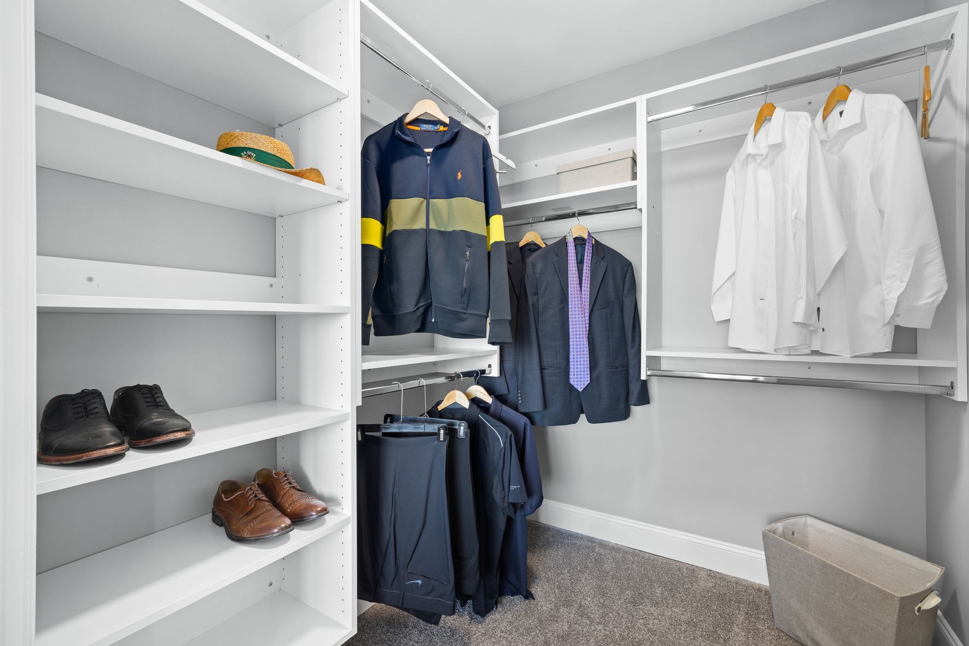 A walk in closet filled with clothes and shoes.