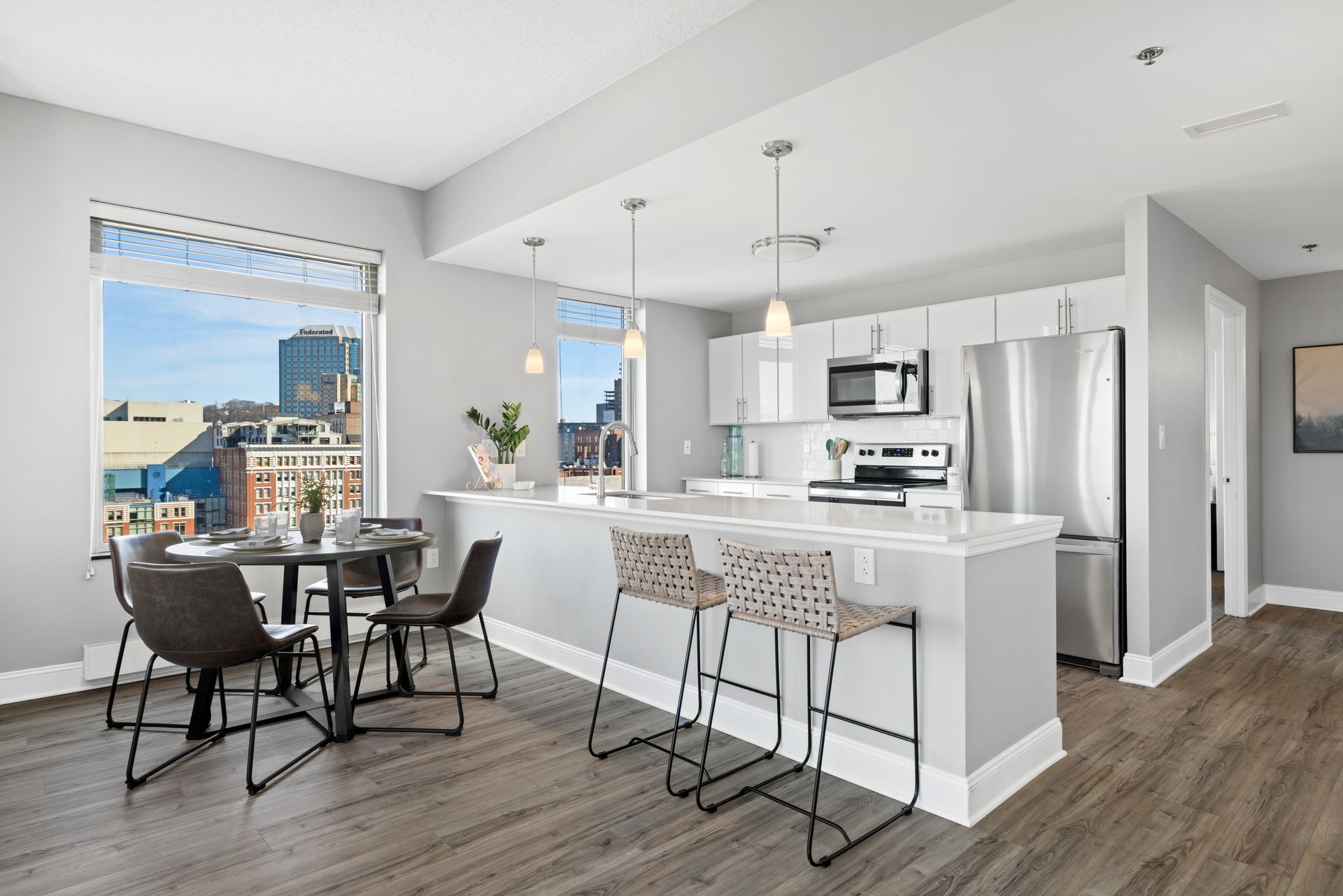 A kitchen with a table and chairs in it