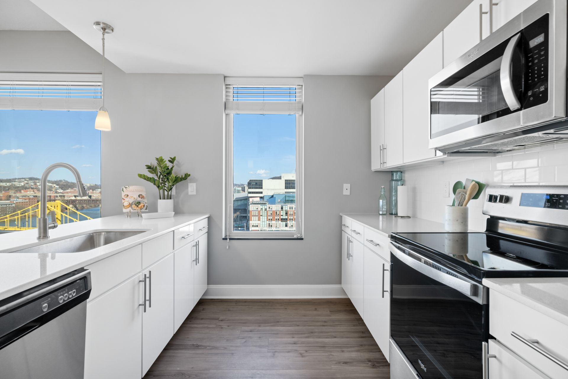A kitchen with white cabinets and stainless steel appliances