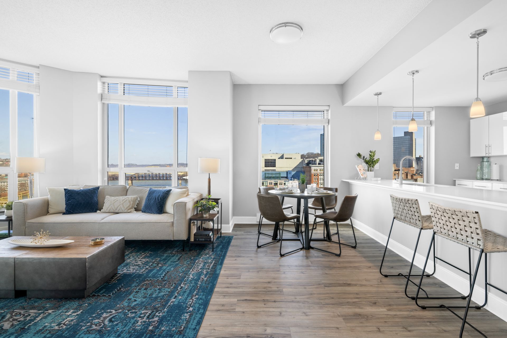 A living room with a couch , table and chairs