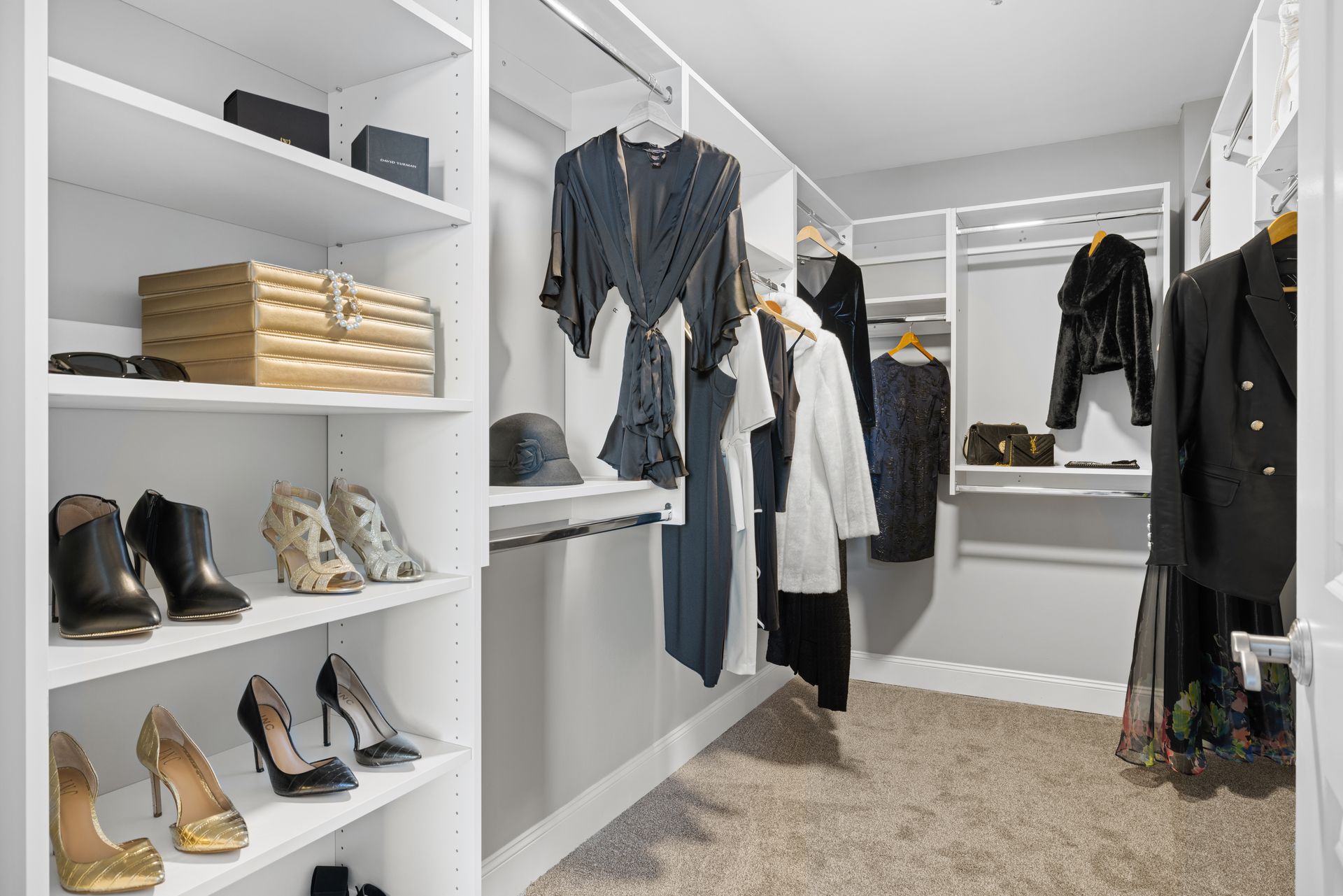 A walk in closet filled with clothes and shoes.