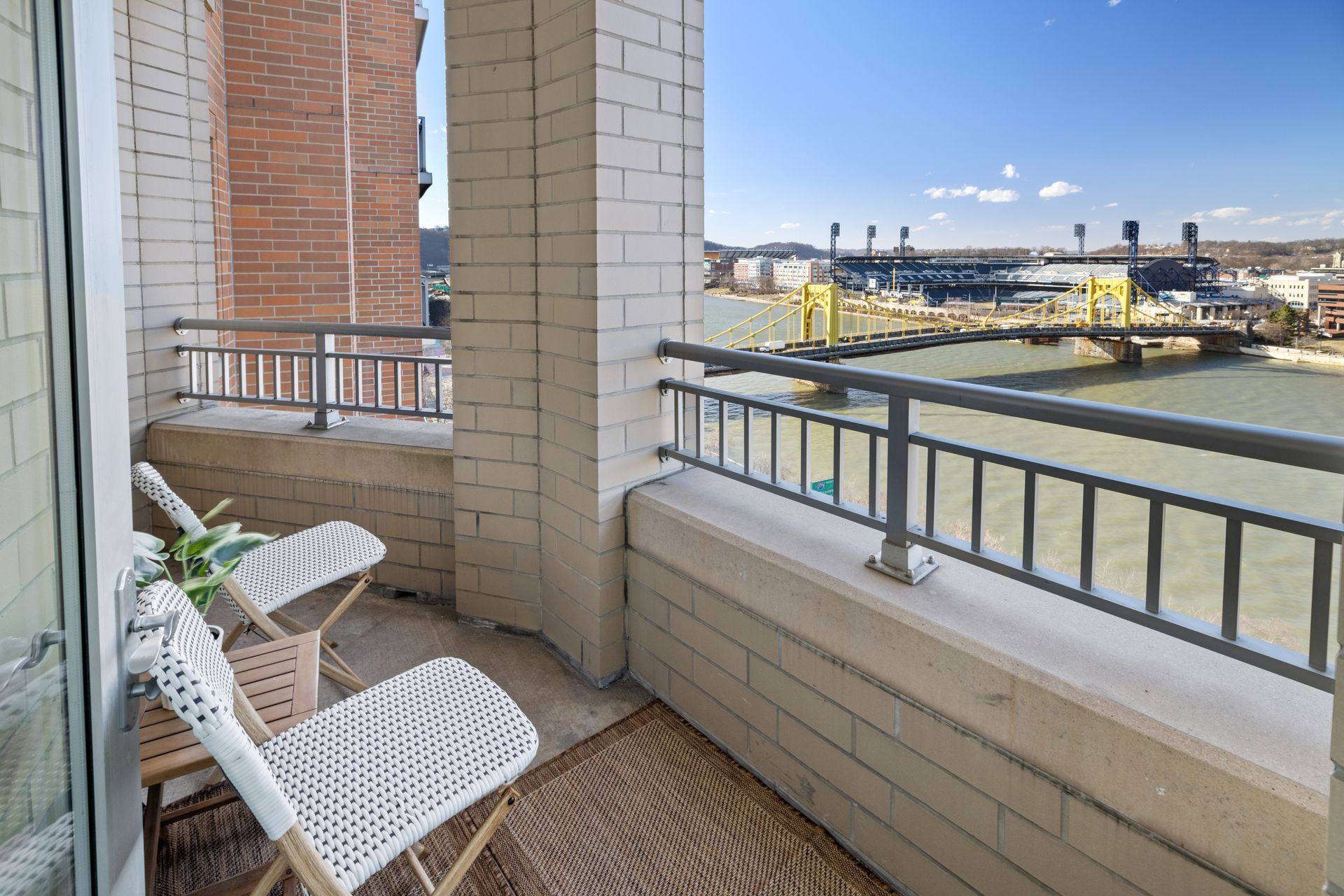 A balcony with a view of a river and a bridge