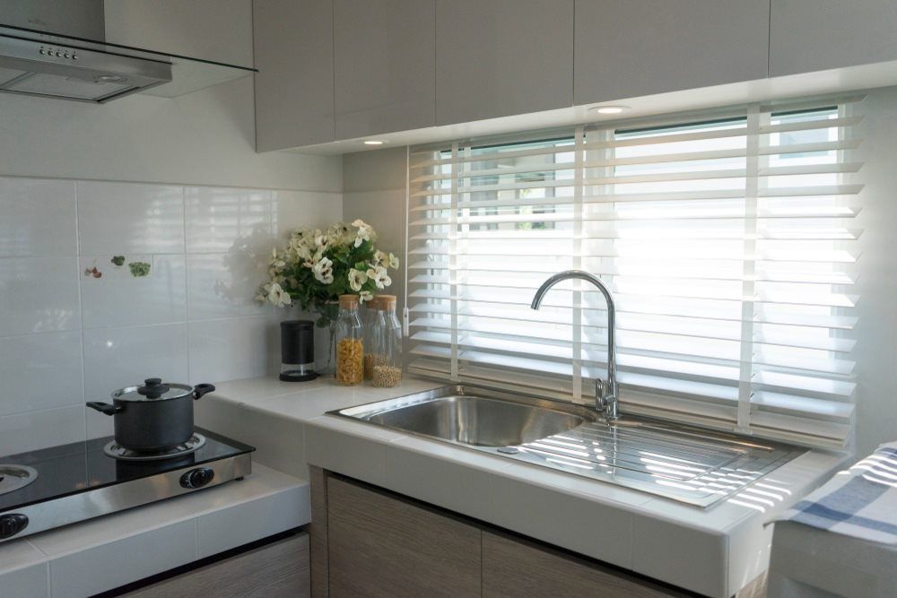 white venetian blinds in bright kitchen