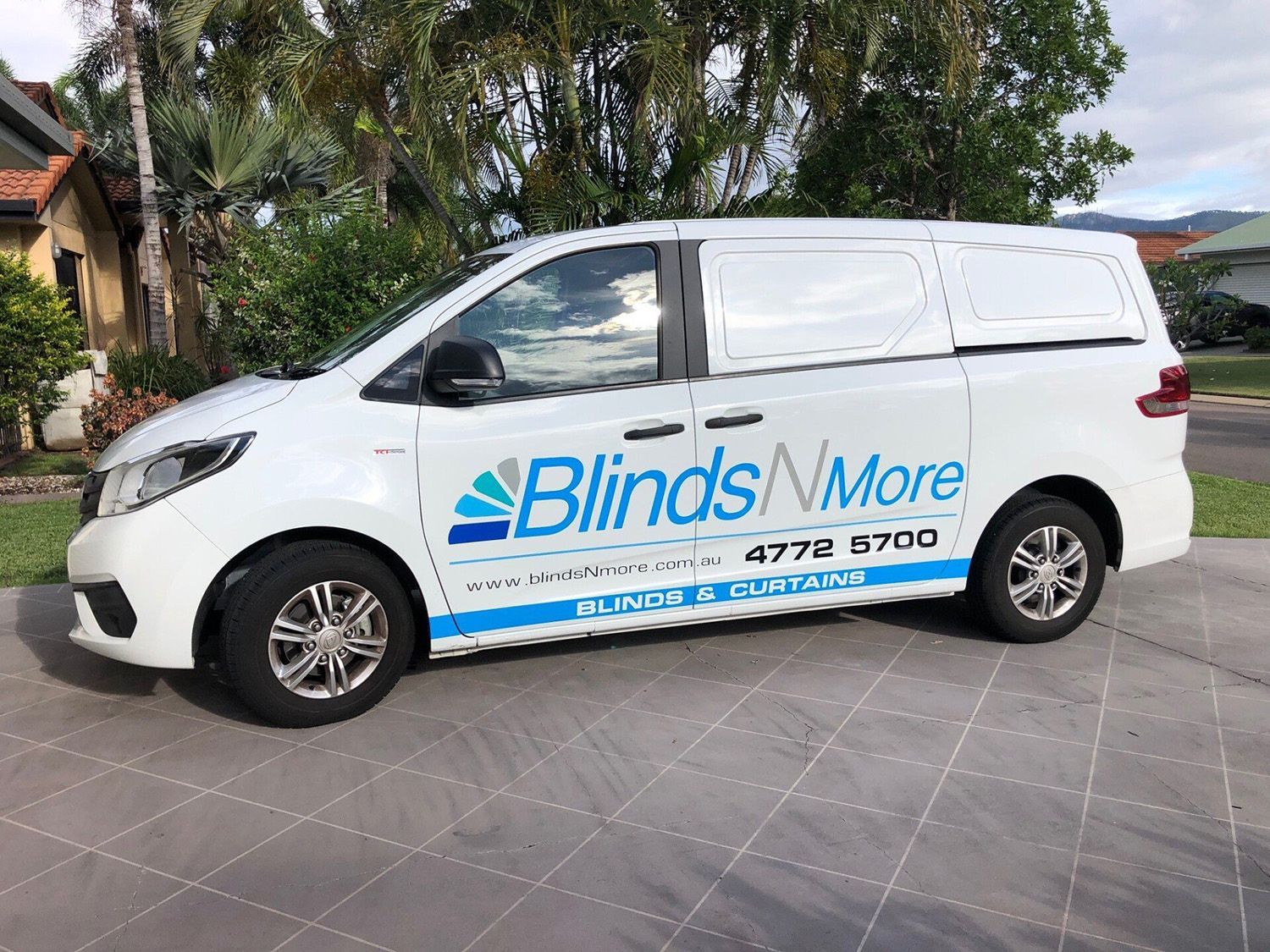 White Van With Blinds N More Logo Parked On A Driveway