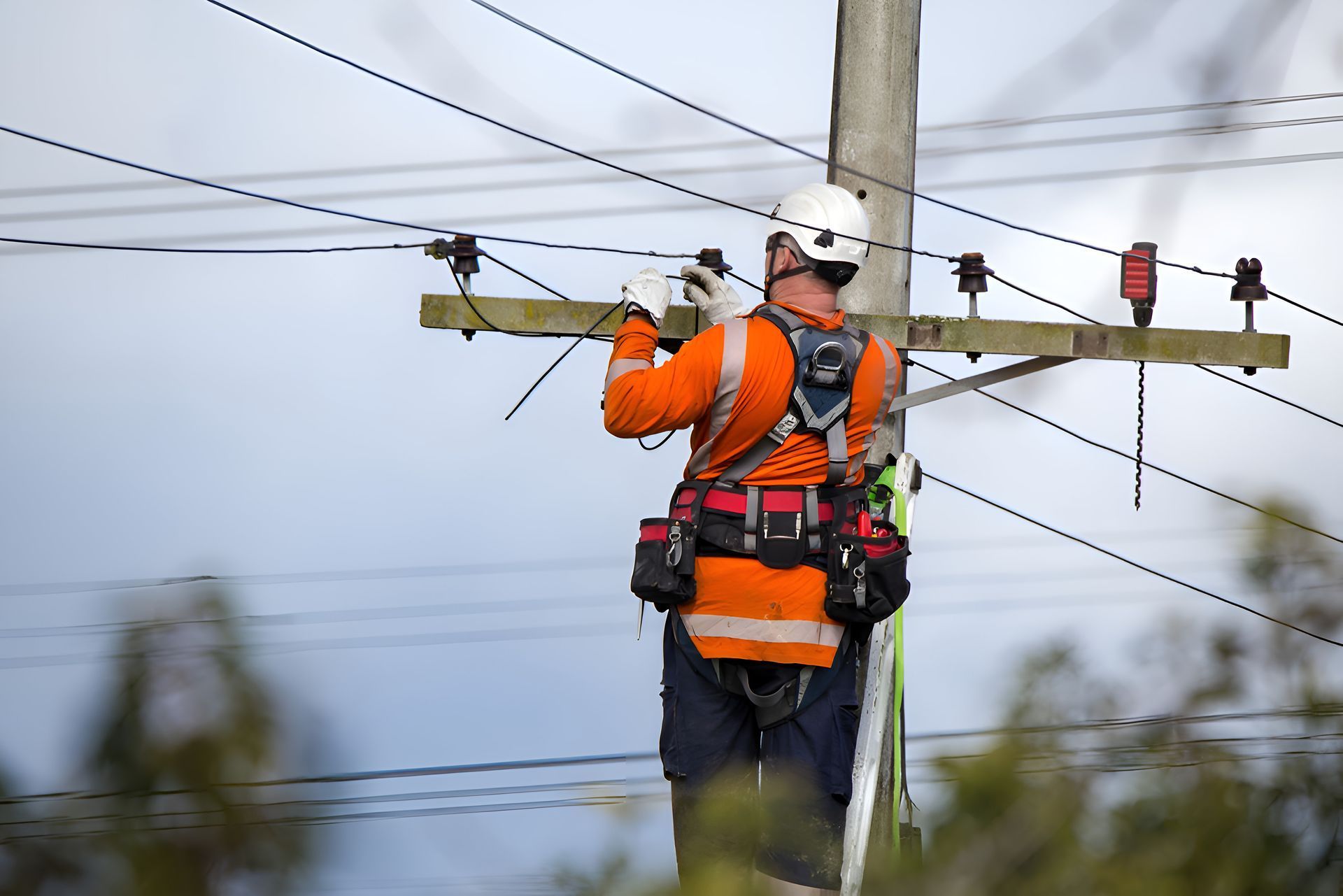 A Man Is Working On An Electrical Panel In A Factory — Entire Power Solutions In Branxton, NSW