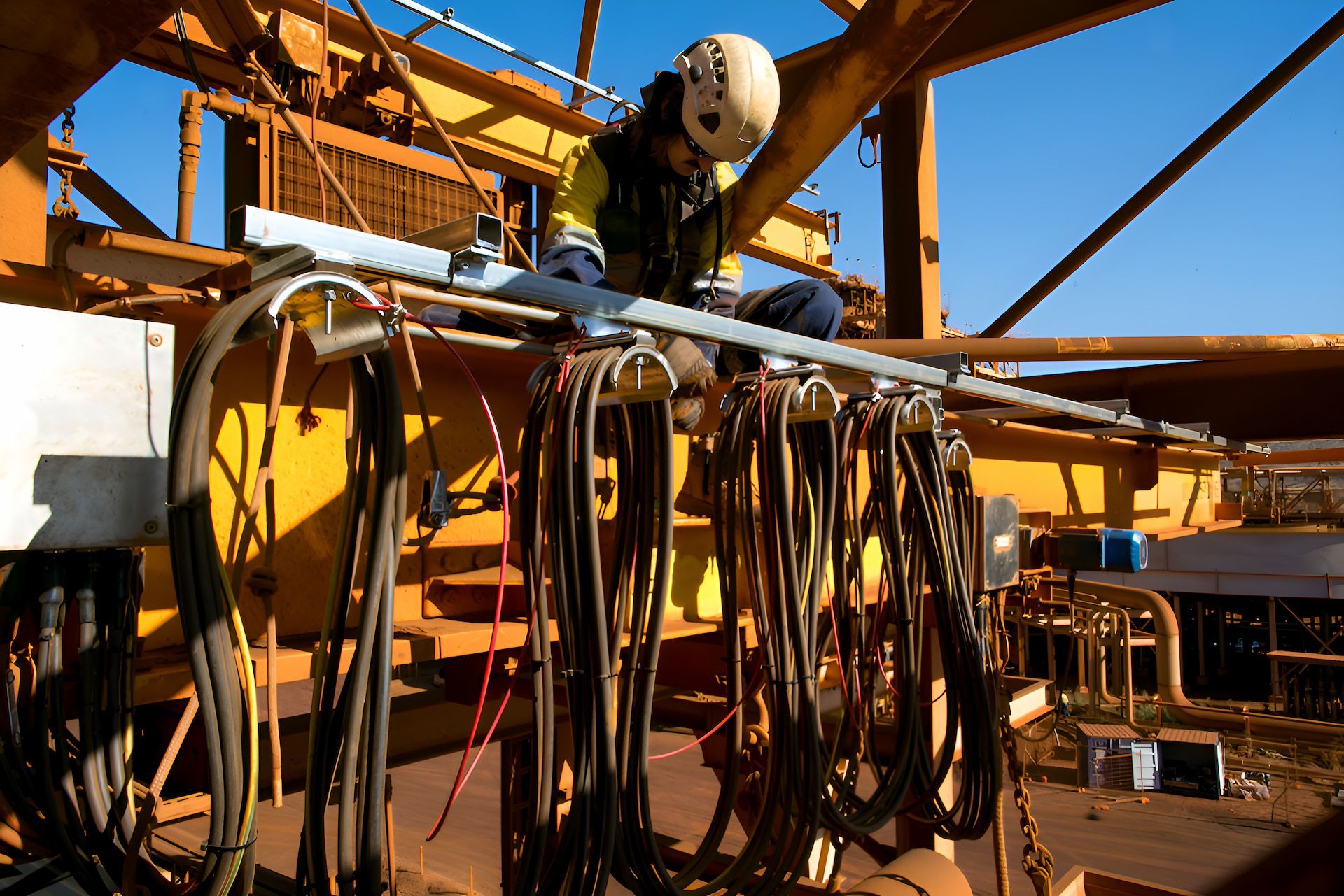 A Man Is Working On A Yellow Machine With Lots Of Cords — Entire Power Solutions In Maitland, NSW