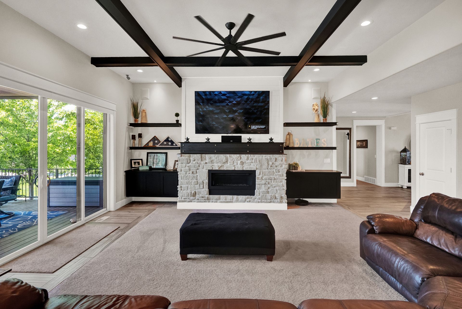 A living room with a fireplace and a flat screen tv on the wall.