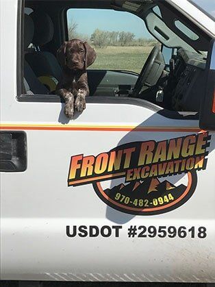 Front Range Excavation Logo on White Truck — Road Grading in Laporte, CO