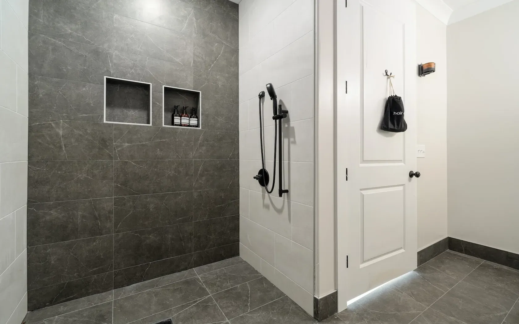 A bathroom with a walk in shower and a door.