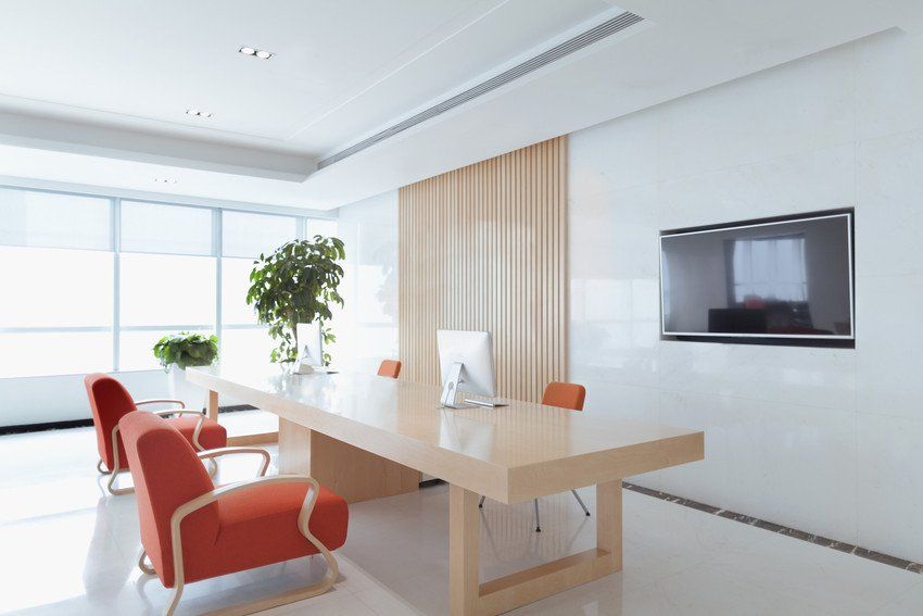 Man painting a brick wall in red