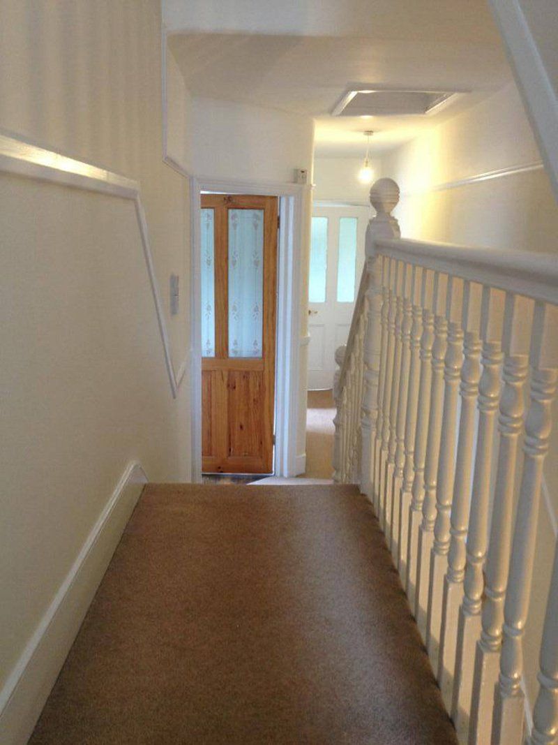 white banister and wooden door