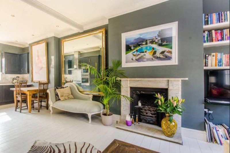 grey and white room with fireplace and plants